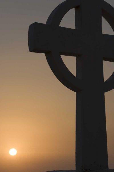 Greece, Santorini Greek cross against sunset
